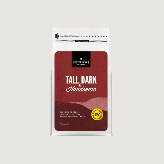 A coffee beans blend bag label for Tall Dark & Handsome with deep maroon and red colours and wavy patterns