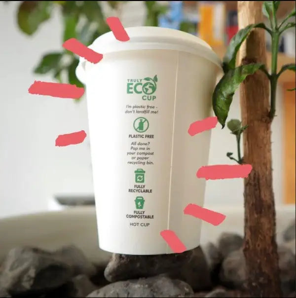 An compostible paper coffee cup sits under a small coffee sapling and highlights the benefits of the eco cup