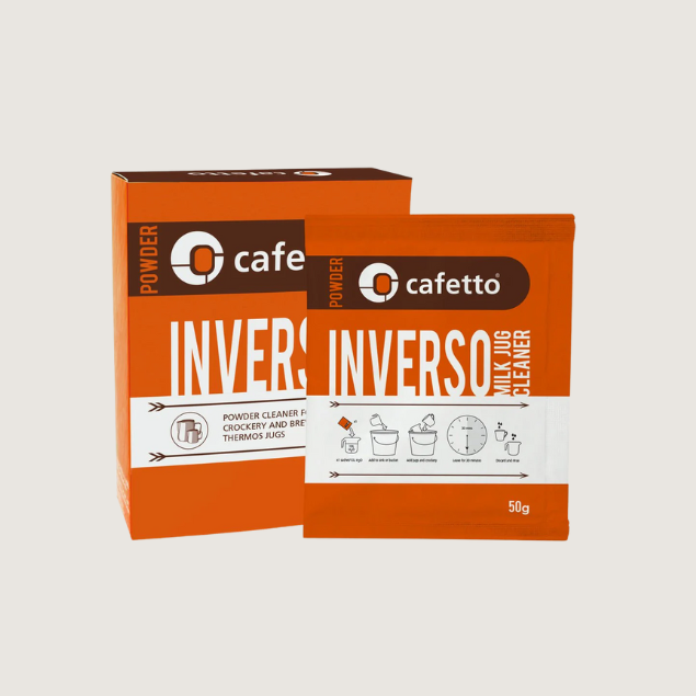 Cafetto Inverso Milk Jug Cleaner powder in an orange box and sachet, designed for removing milk residue from coffee milk jugs, crockery, and thermos jugs. A powerful coffee equipment cleaner for home and professional baristas.